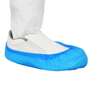 600-5050 Integrity Polythene Overshoes Blue Cleanroom Shoe Cover over a slip-on cleanroom shoe. The cleanroom operative is also wearing cleanroom clothing on their leg